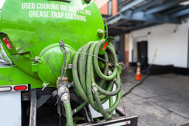 a technician pumping a grease trap in a commercial building in Hamilton, NJ